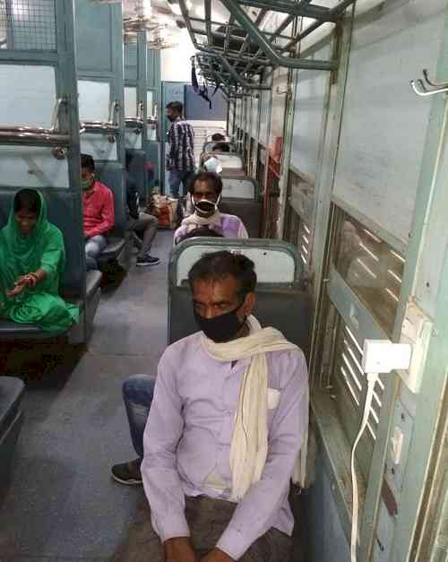 After boarding `shramik express' migrant laborers cheer over arrangements of Punjab government