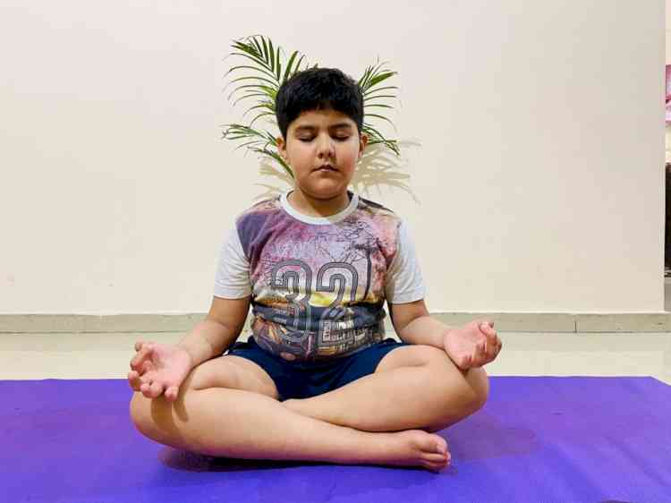 Children awarded certificates of participation for taking part in yoga session on international yoga day