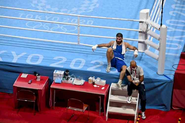 French boxer disqualified for headbutt, sits on ringside in protest