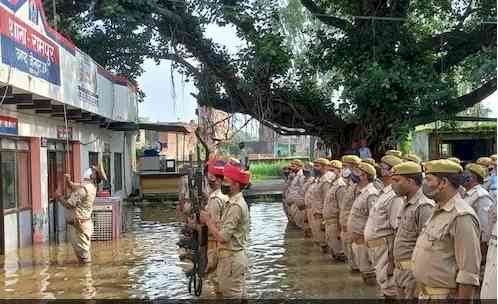 UP police stand in knee-deep water to hoist national flag
