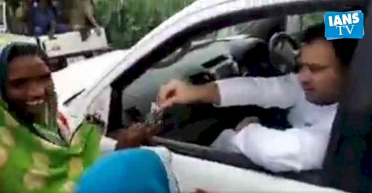 Candid camera: Tejashwi 'caught' distributing money to villagers ahead of polls