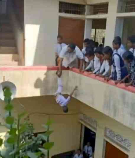 UP: Principal hangs kid upside down from building