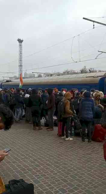 Students queue up at Kharkiv railway station as doors of trains remain shut