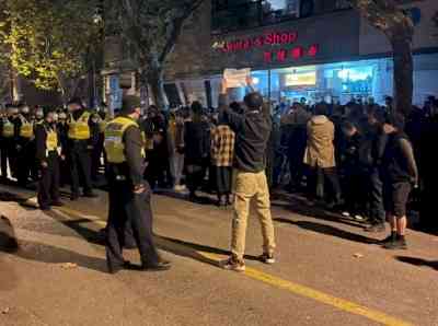 Police barricade street in Shanghai after two nights of protests