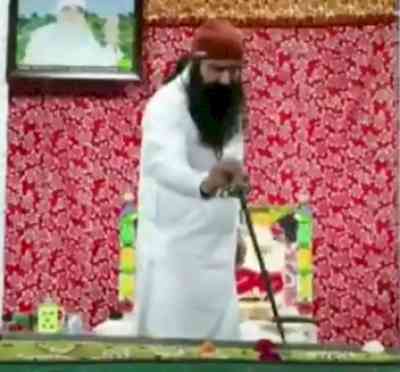 Ram Rahim cuts cake with a sword to celebrate his parole