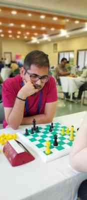 Visually impaired chess player Darpan Inani shows his opponents he