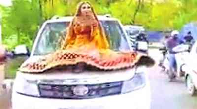 Bride rides on car bonnet, gets fined by UP cops