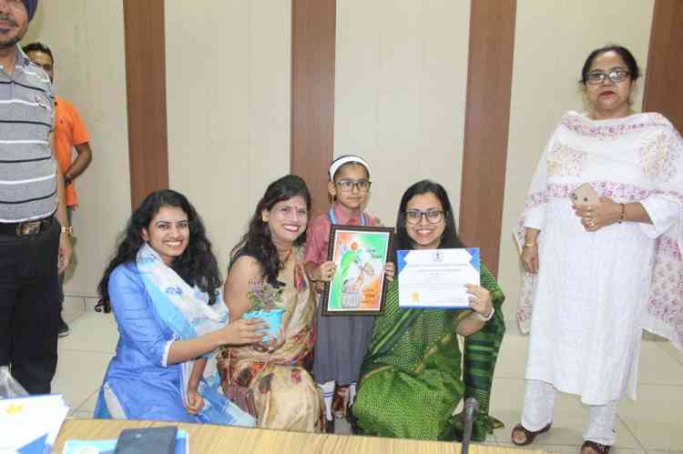 Administration felicitates 52 students for best artwork, certificates and saplings given by DC 
