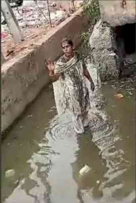 Woman stands in dirty nallah to protest after failing to meet K'taka minister