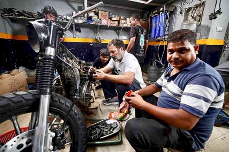 Rahul Gandhi interacts with bike mechanics in Delhi