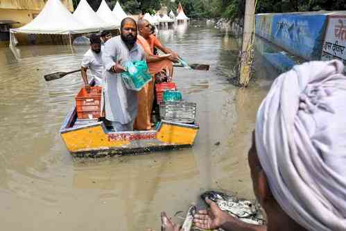 Powerlifter-turned-shooter Gaurav Sharma distributes food items to flood-affected people in Delhi