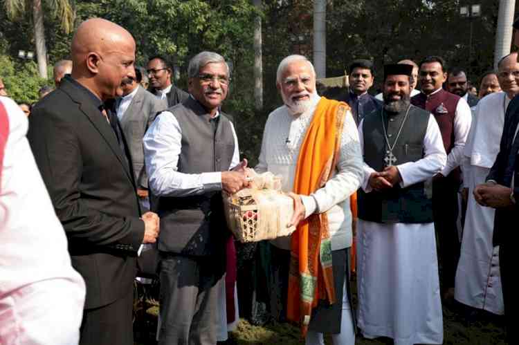 ESAF Small Finance Bank MD and CEO K. Paul Thomas presents Prime Minister Narendra Modi a Christmas gift hamper