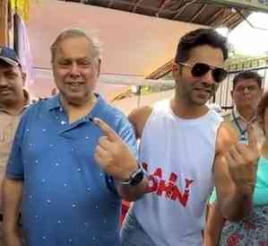 Varun helps his father David Dhawan as they step out to vote in Juhu