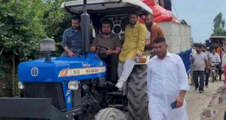 Jalalabad MLA takes tractor to flood-hit village with animal feed, interacts with locals