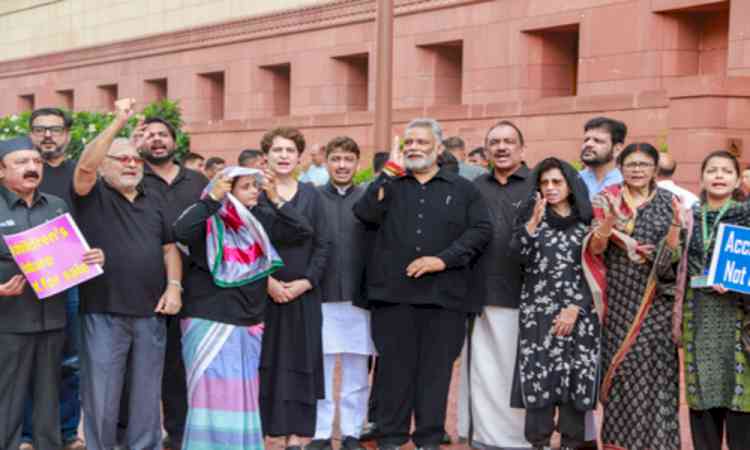 Oppn MPs in black protest outside Parliament House over NEET paper leak, police cruelty