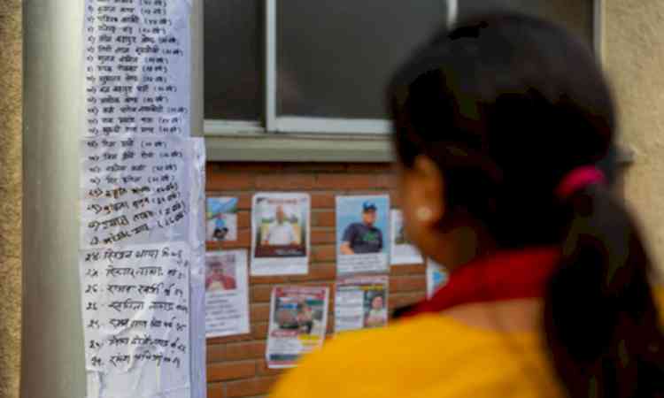 Families put up posters outside Kathmandu hospital in hope of finding their loved ones
